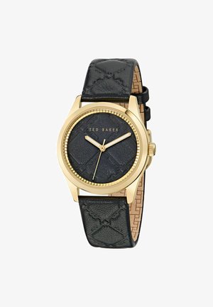 Black leather strap watch with textured black dial, gold-tone casing and hands, featuring a patterned strap and brand name embossed on the face.