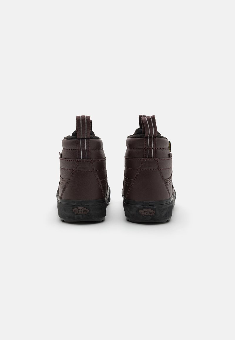 Brązowe sneakersy typu high-top z teksturowanej skóry, wyściełanym kołnierzem, pętlami do ściągania oraz czarnymi gumowymi podeszwami. Posiadają kontrastowe przeszycia oraz detale z logo.