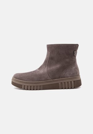 Brown suede ankle boot with a textured rubber sole and side button detail on a white background.