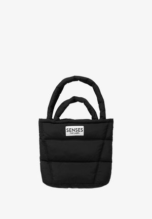 Black padded tote bag with dual rounded handles and a rectangular shape. Features a logo patch on the front. Soft texture with visible stitching.