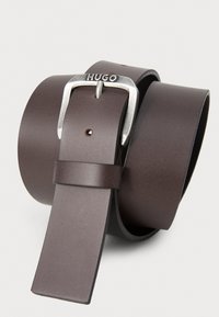 Brown leather belt with a square silver metal buckle. The buckle features the word "HUGO." Smooth texture, tapered end, and adjustable holes.