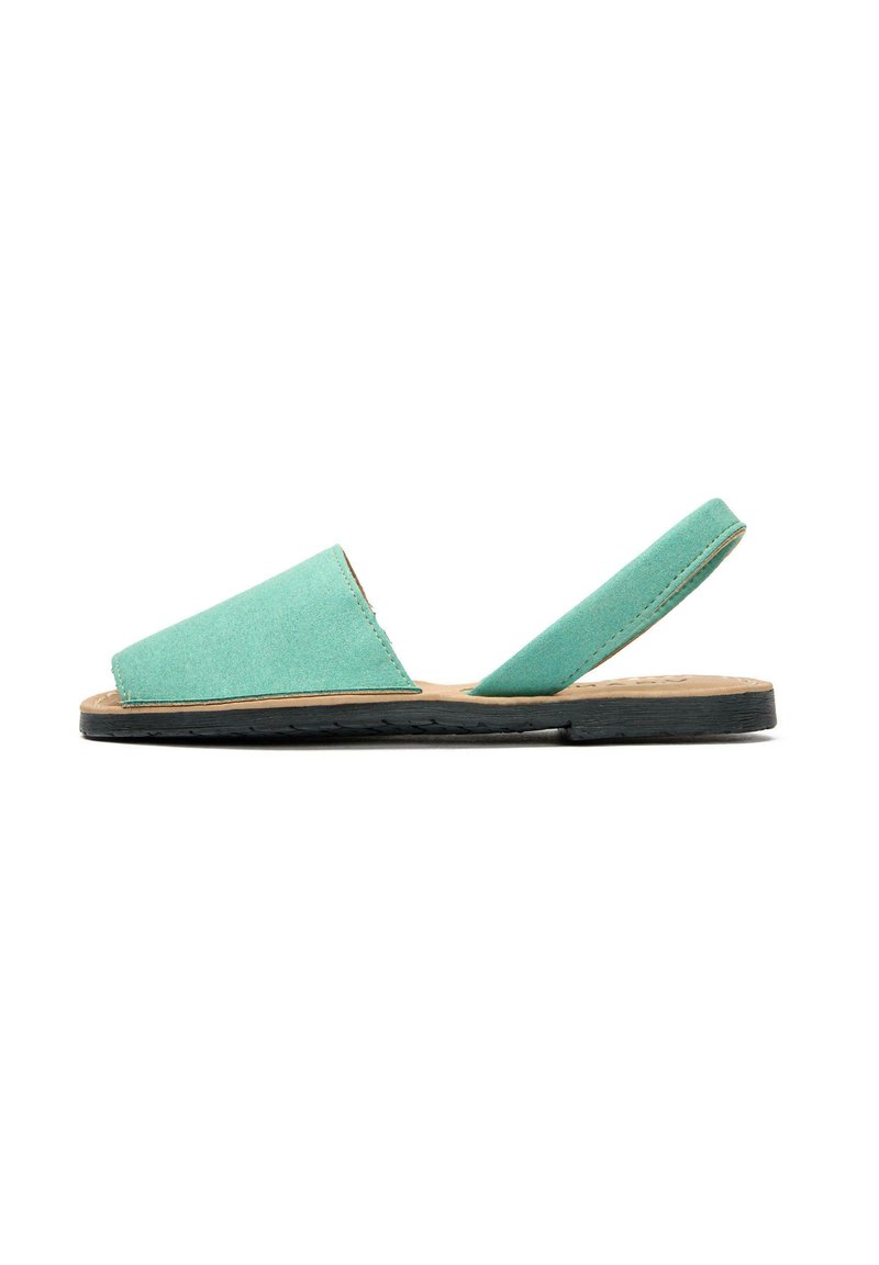 Mint green flat sandals with a soft, textured upper, open strap design, black rubber sole, and a natural beige footbed.