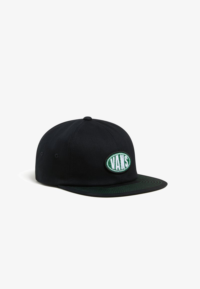 Black cap with a flat brim, featuring a green embroidered oval patch with "VANS" text. Smooth fabric texture, simple design.