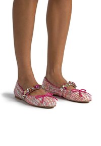 Ballet flat in tessuto intrecciato rosa e bianco con texture, dotate di una fascia con gemme e un dettaglio a fiocco rosa sulla punta.