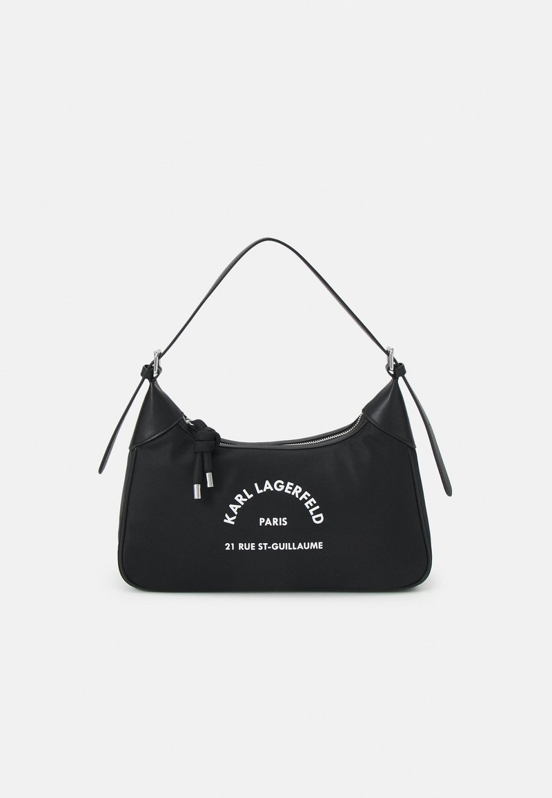 Black nylon handbag with a curved shape, featuring a top handle, silver hardware, and white text detailing: "KARL LAGERFELD PARIS 21 RUE ST-GUILLAUME."