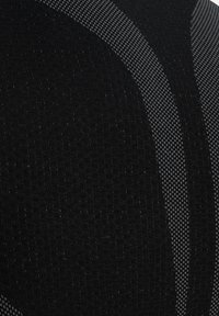 Black fabric with small textured dots and curved gray woven stripes creating a geometric pattern.