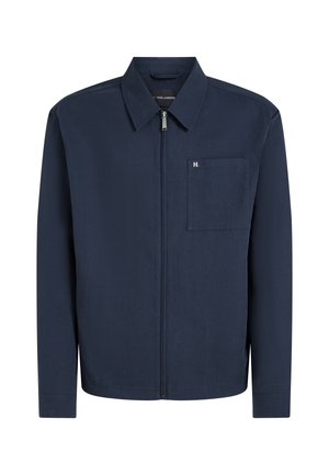 Veste zippée bleu marine, dotée d'un col, d'une poche poitrine et d'un détail de logo discret. Conçue en tissu lisse avec une coupe structurée.
