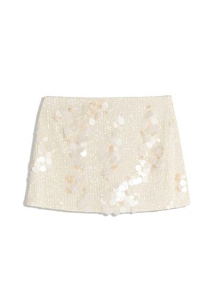 Mini gonna bianca con una superficie testurizzata e decorazioni di paillettes. Presenta paillettes rotonde iridescenti sparse che creano un effetto lucente.