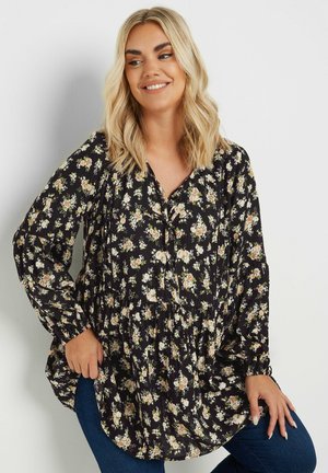 Black floral blouse with a loose fit, featuring a buttoned placket and elasticized cuffs. White and pastel floral patterns throughout.