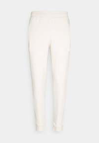 Harmaita trikoot, jotka on valmistettu pehmeästä kankaasta. Ominaisuuksiin kuuluvat kapeneva muotoilu, joustava vyötärö, kaksi sivutaskua ja pieni logodetali.