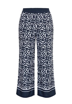 Marineblauwe en witte wijde pijpen broek met elastische tailleband en gedurfd symmetrisch bloemenpatroon, met een effen marineblauwe zoom met witte strepen.
