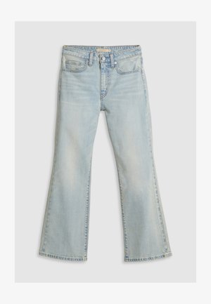 Lys blå utvidede jeans laget av denim. Har en mid-rise midje, to frontlommer og synlig søm langs sømmene.