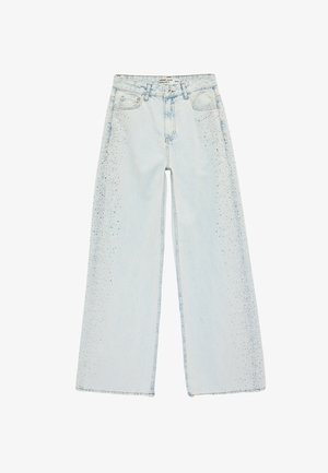 Lyseblå vidde jeans med høj talje og et diskret mørkt plettet mønster langs ydersiden af benene.