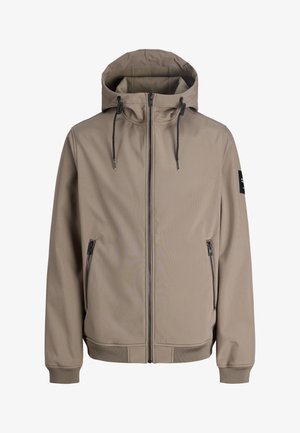 Beżowa kurtka z kapturem zapinana na zamek błyskawiczny z przodu, ze ściągaczami przy kapturze, zapinanymi na zamek bocznymi kieszeniami, ściągaczami na mankietach oraz czarną naszywką na lewym rękawie.