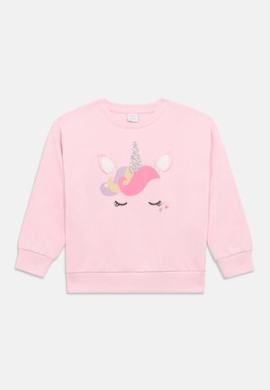 Light pink long-sleeve sweatshirt with a closed-eye unicorn face, glittery horn, pastel mane, white ears, and small heart accents on front.