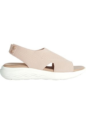 Sandalia tipo slingback de color rosa claro con parte superior de tela trenzada, punta abierta y suela blanca texturizada con patrones de olas. Dos acentos de botón cerca del talón.
