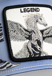 Cap featuring a white embroidered patch with a gray winged horse design, black trim, and the word "LEGEND." Blue fabric base with stitching details.