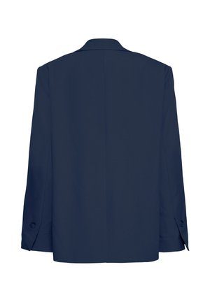 Veste blazer bleu marine suspendue, dos tourné vers l'avant, montrant les manches longues et les détails des boutons aux poignets.