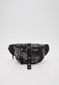 Black fanny pack with a glossy floral pattern in white. Features multiple zippered pockets and a central strap with decorative hardware.