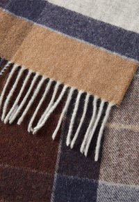 Wool scarf featuring a brown, gray, navy, and burgundy checked pattern, with white fringes at one edge and a soft, fuzzy texture.
