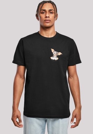 Black cotton t-shirt featuring a cartoon dog graphic on the left chest area. Crew neckline, short sleeves, and relaxed fit.