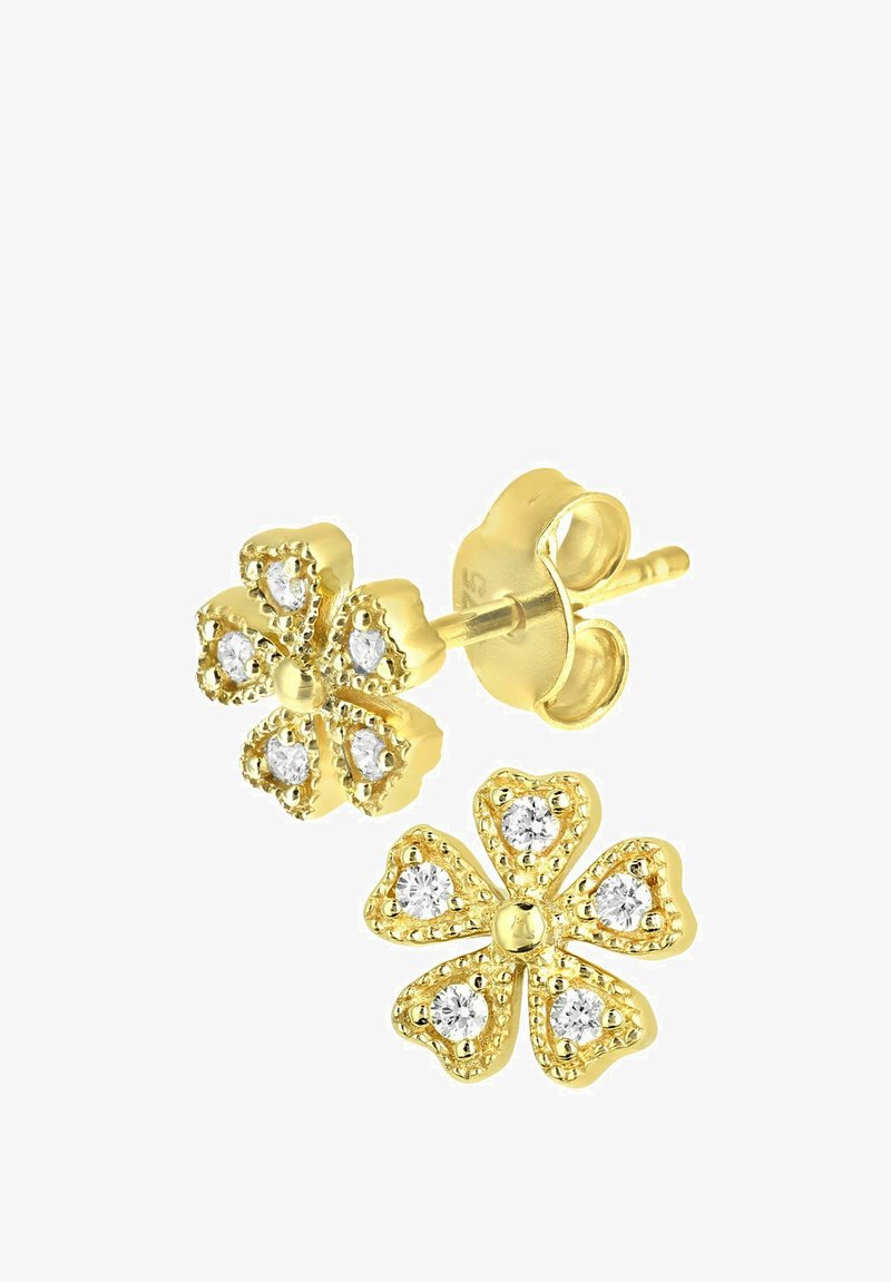 Guldtonede blomstformede studs med hjerteformede kronblade og funklende klare sten i midten, med en tekstureret kant.