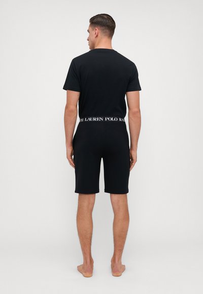 Set de tricou și pantaloni scurți din bumbac negru, cu un design simplu și un brâu alb contrastant cu textul "RALPH LAUREN".