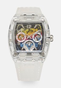 Montre en plastique transparent avec un cadran rectangulaire, un cadran multicolore présentant des index horaires en chiffres et trois sous-cadrans. Bracelet blanc avec des accents texturés.