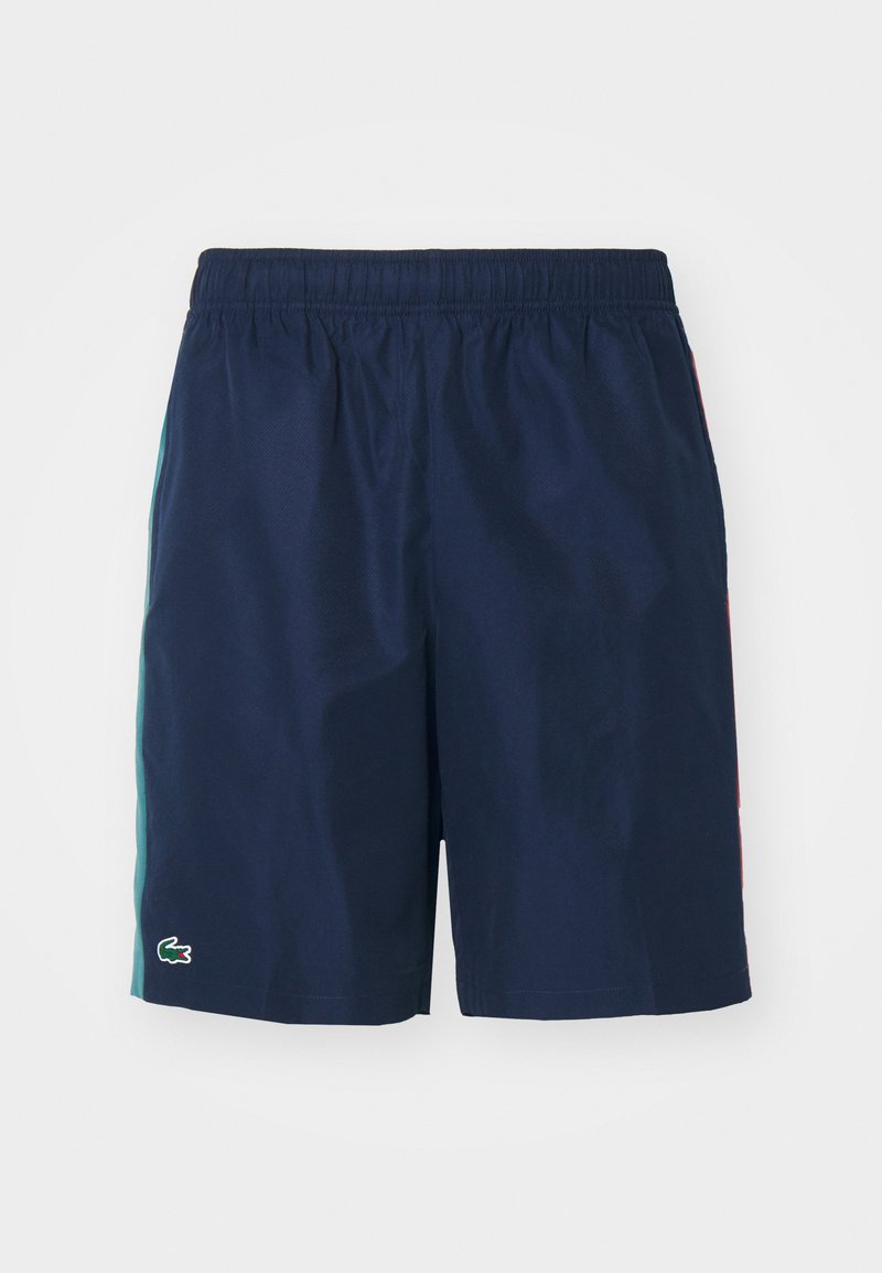 Shorts de bain bleu marine avec une taille élastique, des rayures latérales en teal et rouge, et un petit logo brodé en bas à gauche.
