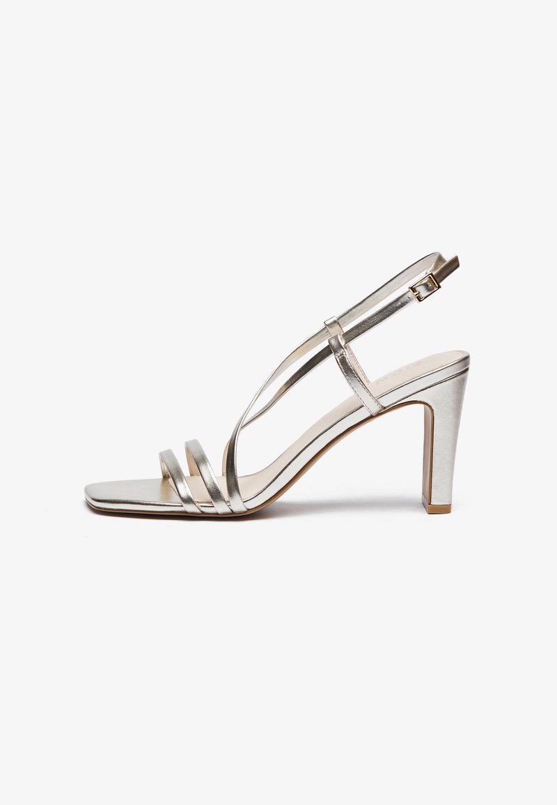 Metallic silver high-heel sandal with an open toe, featuring three thin straps across the foot and an ankle strap with a buckle.