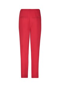 Red trousers with a smooth texture, tapered design, and two back pockets. Features a zipper and button closure at the waist.