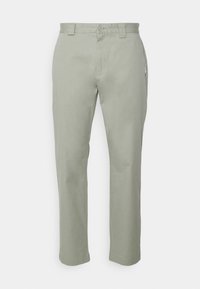 Light green, straight-leg pants made of cotton. Features a button closure and a side pocket with a logo tag. Smooth texture, tailored design.
