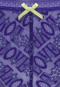 Purple lace lingerie features a "LOVE" text pattern, sheer texture, and a yellow-green satin bow accent at the top.