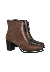 Botas de ante marrón hasta el tobillo con acentos metálicos, cremalleras laterales, tacones cuadrados y una suela blanca en contraste. Acabado suave en las punteras.