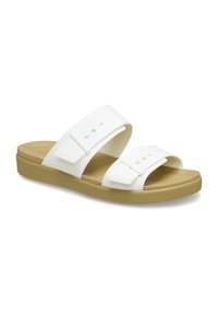 White slide sandals featuring two wide straps, smooth texture, and a contoured tan footbed with a flexible beige outsole.