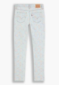 Jeans de mezclilla azul claro con un estampado floral en colores pastel, de corte skinny, con bolsillos traseros y una etiqueta de cuero marrón de la marca en la cintura.