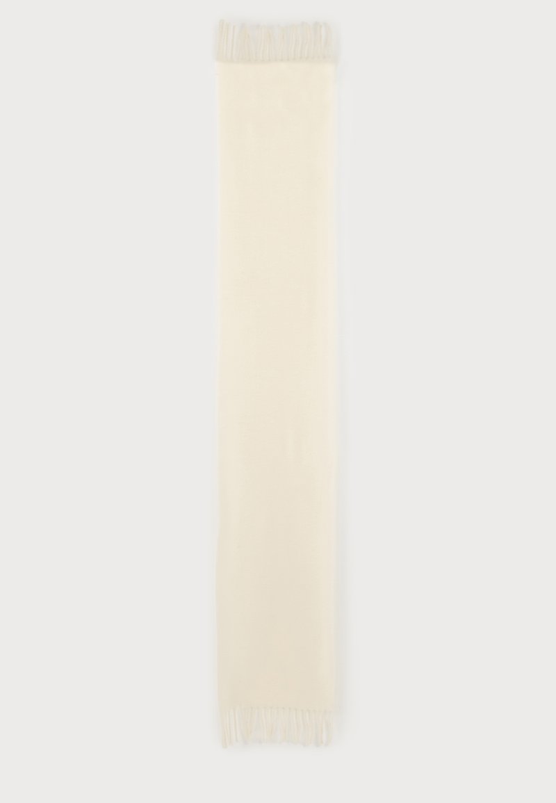 Longue écharpe rectangulaire de couleur crème avec des franges aux deux extrémités, présentée à plat sur un fond clair.