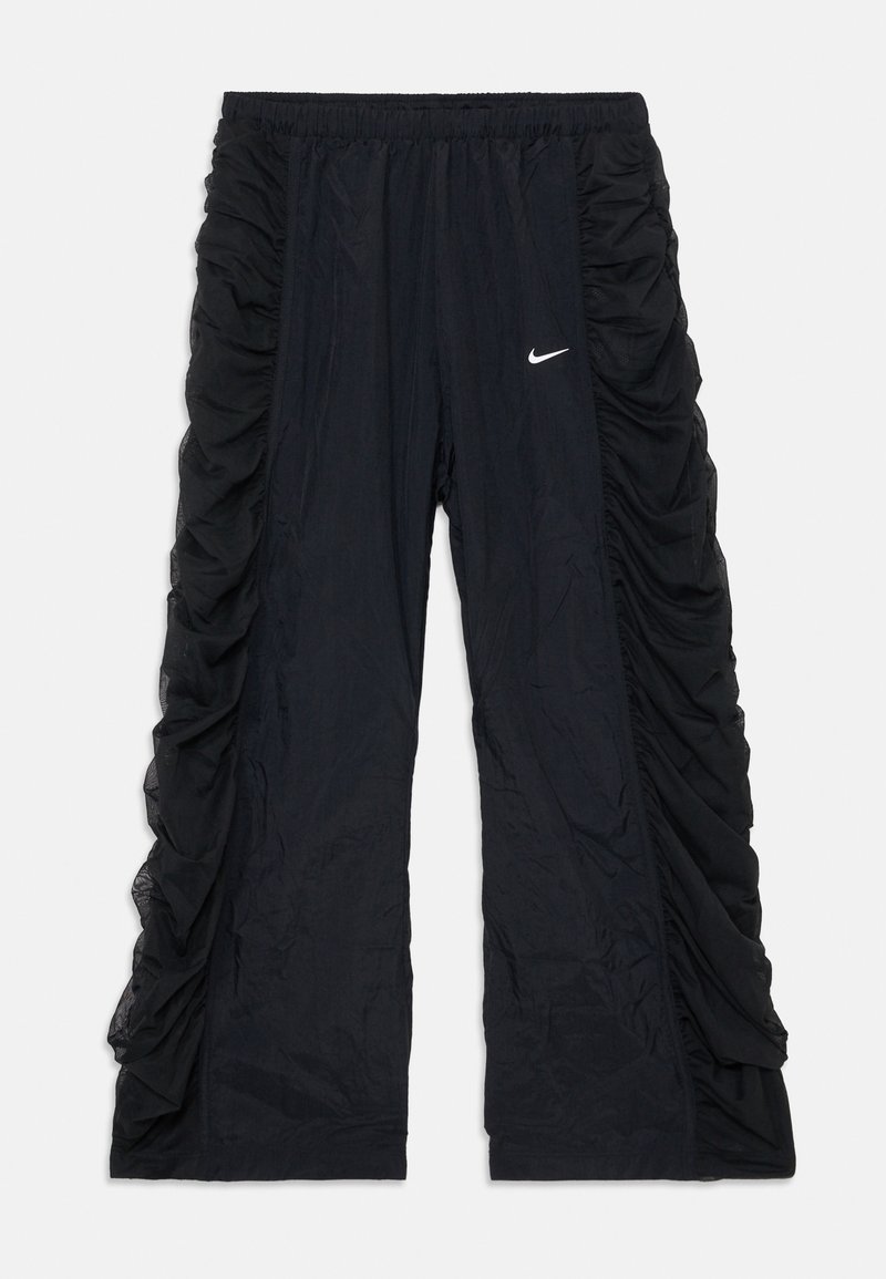 Čierne športové nohavice s bočnými gumičkami, elastickým pásom a malým bielym logom Nike na prednej strane. Ľahký materiál.