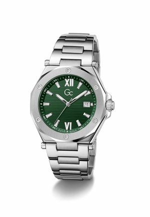 Edelstahluhr mit grünem Zifferblatt, silbernen Stundenmarkierungen, römischen Zahlen XII und VI, Datumsanzeige und Metallgliederarmband.