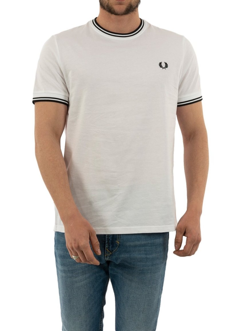 White cotton t-shirt with black ribbed collar and sleeve cuffs, featuring a small black embroidered logo on the chest and a relaxed fit.