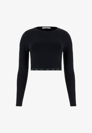 Zwarte lange mouw crop top van zacht materiaal, met een ronde halslijn en een tailleband met een witte "GUESS" logo-detail.