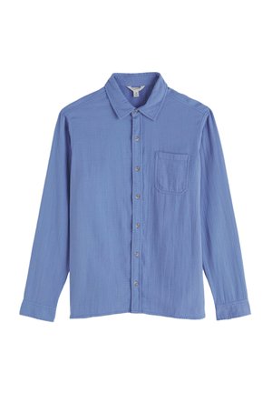 Camasa albastru deschis cu mâneci lungi, cu nasturi, realizată dintr-un material moale. Are guler, un buzunar frontal și șase nasturi în față.