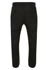 Pantaloni de jogging negri din bumbac, cu un elastic în talie, picioare ajustate și o textură netedă, potriviți pentru îmbrăcăminte casuală sau exerciții fizice.