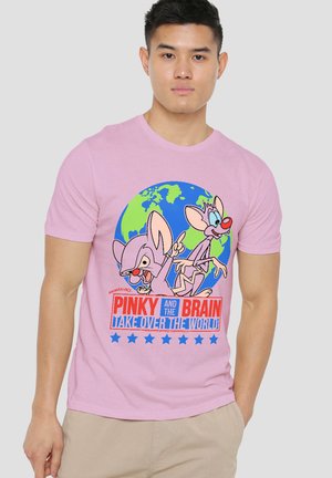 Man wearing a pink t-shirt with cartoon mice Pinky and the Brain, a globe graphic, and the text “Pinky and the Brain Take Over the World.”