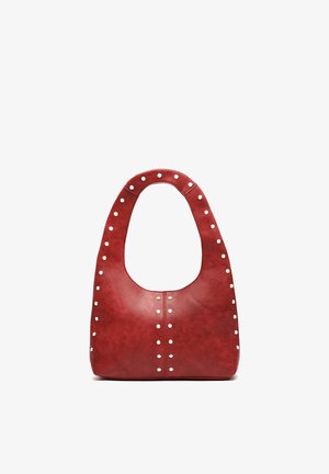 Red leather handbag with a wide handle, adorned with evenly spaced small silver studs along edges and center seam.