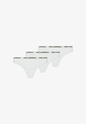 Drie witte string-onderbroeken met een zwarte "KARL LAGERFELD"-logo op de tailleband, gerangschikt in een verspringende rij.