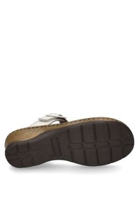 Tan and brown sandal sole with textured rubber outsole. White leather strap with silver hardware detail. Contoured footbed for comfort.