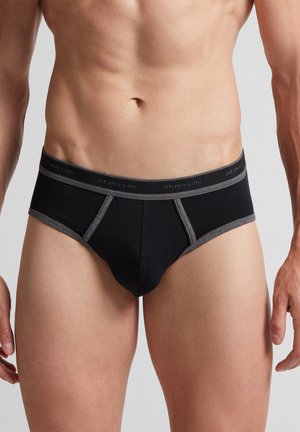 Schwarze Baumwollslips mit grauen Akzenten. Der elastische Bund trägt das Markenlogo. Klassische Passform, nahtlose Seiten und minimalistisches Design.
