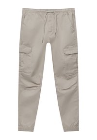 Beige cargo pants made of soft fabric, featuring an elastic waistband with drawstring, side pockets, and two large cargo pockets.