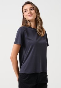 T-shirt grigio scuro a maniche corte realizzato in cotone liscio. Presenta un collo rotondo e una vestibilità rilassata. Design semplice senza motivi.